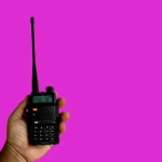 vecteezy_a-portable-radio-transmitter-holding-in-hand-blurred-an_13945584