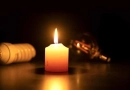 vecteezy_a-white-burning-candle-in-close-up-on-a-black-surface_44219700