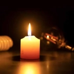 vecteezy_a-white-burning-candle-in-close-up-on-a-black-surface_44219700