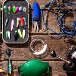 vecteezy_accessories-for-fishing-on-the-background-of-wood-top-view_34238008