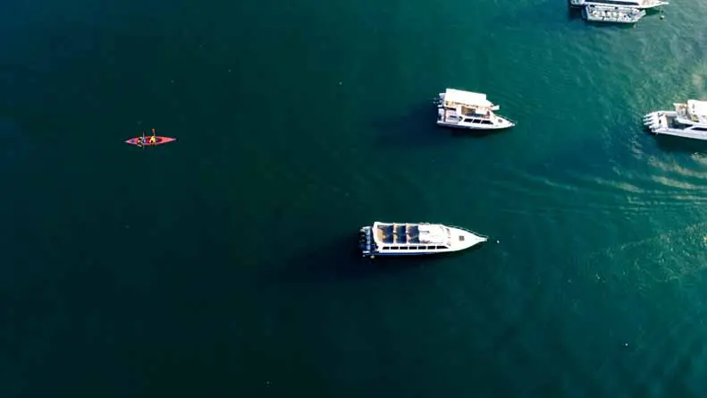 vecteezy_boats-on-blue-water-drone-shot_28883262