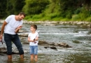 What Kind of Fishing Rod and Reel Should I Use as a Beginner? vecteezy_father-teaching-son-how-to-fly-fish-in-river_42589441