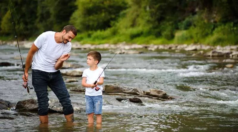 vecteezy_father-teaching-son-how-to-fly-fish-in-river_42589441