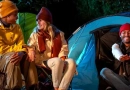 What’s the Best Clothing to Wear for Camping? vecteezy_group-of-people-are-sitting-in-front-of-a-tent-camping-in_46699637