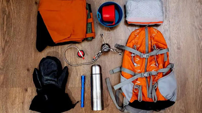 vecteezy_hiking-equipment-backpack-pants-thermos-mittens_40506791