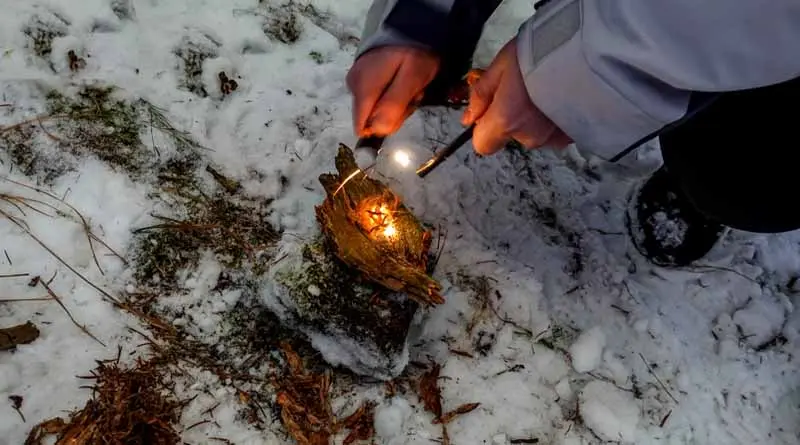 vecteezy_making-fire-with-a-fire-starter-in-the-nature-and-winter_40350582