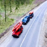 vecteezy_several-cars-with-kayaks-on-roof-rack-driving-on-the-road_11444494