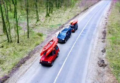 vecteezy_several-cars-with-kayaks-on-roof-rack-driving-on-the-road_11444494