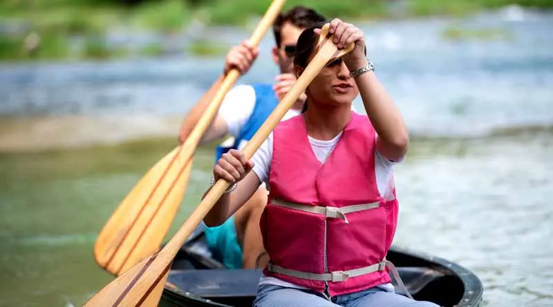 vecteezy_two-athletic-man-floats-on-a-red-boat-in-river_11395320