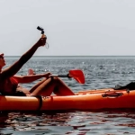 vecteezy_woman-sea-kayak-happy-smiling-woman-paddling-in-kayak-on_45601353