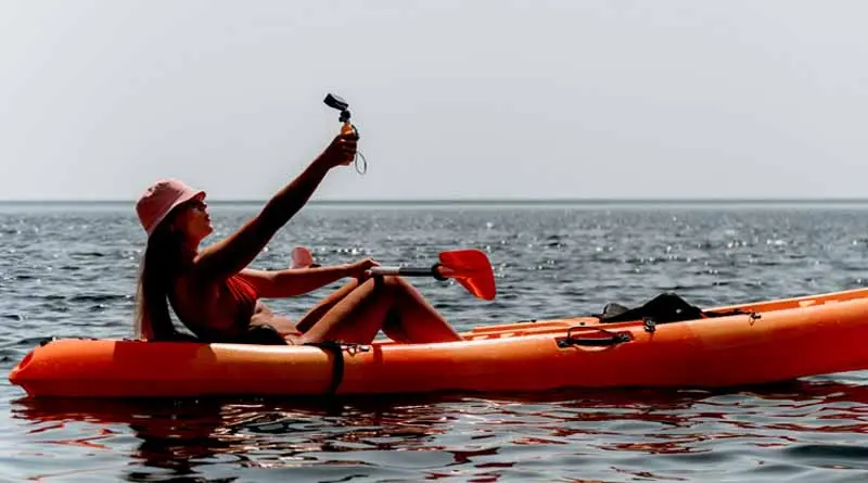 vecteezy_woman-sea-kayak-happy-smiling-woman-paddling-in-kayak-on_45601353