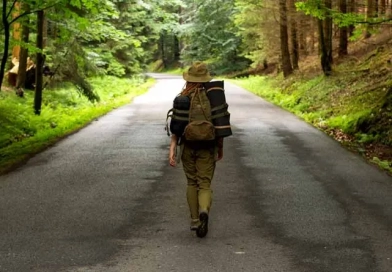 Should You Have A Bug-Out Bag, And What Should It Include? vecteezy_young-woman-hiker-walking-on-narrow-road-through-summer_7665864