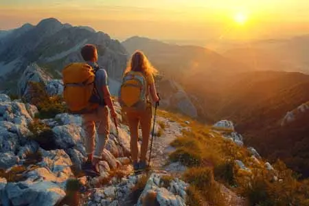 A couple looking out over the mountains while hiking.