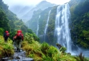 What Are the Most Scenic Hiking Trails in the World? vecteezy_two-people-with-backpacks-walking-up-a-trail-near-a-waterfall_45501510