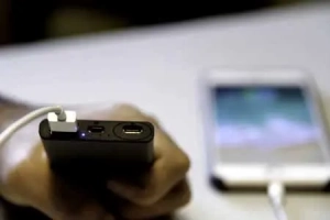 black-power-bank-and-smartphone-on-a-white-table