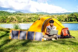 young man enjoying camping with a solar generator