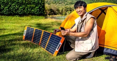 Man using solar charger while camping