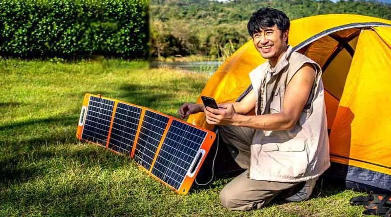 Man using solar charger while camping